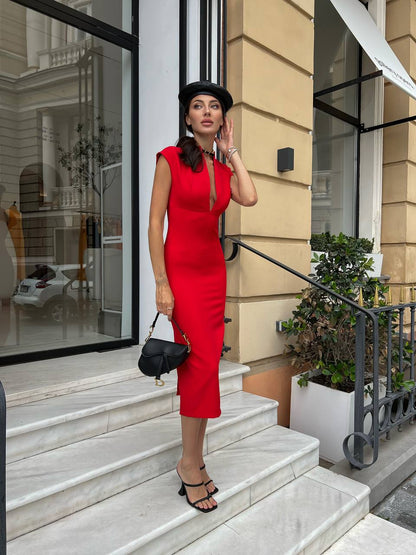 Woman in a red dress standing on steps outside a building