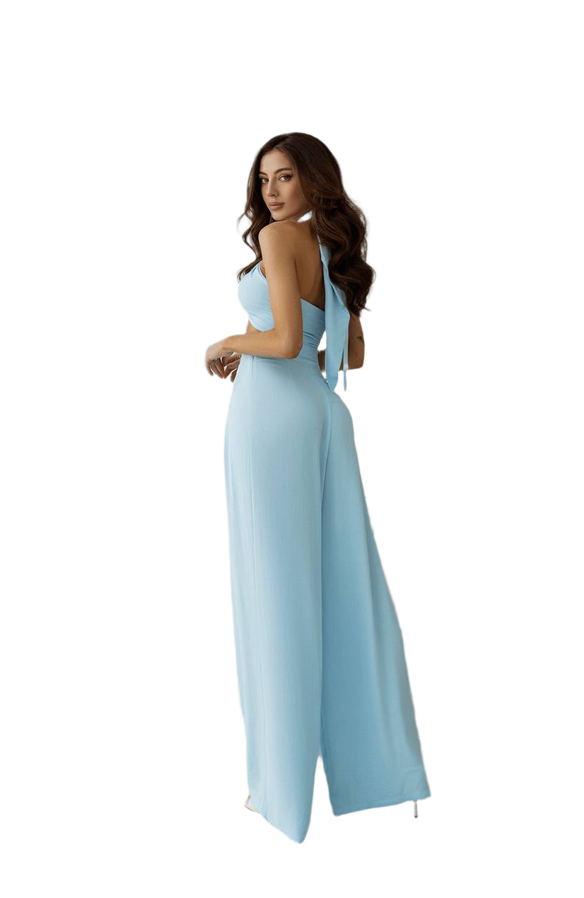 Woman wearing a light blue jumpsuit on a white background