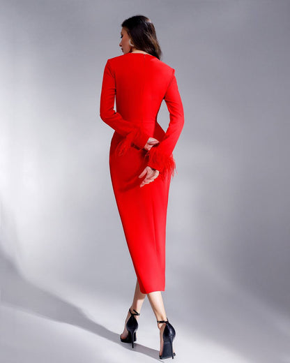 Woman wearing a red dress against a gray background