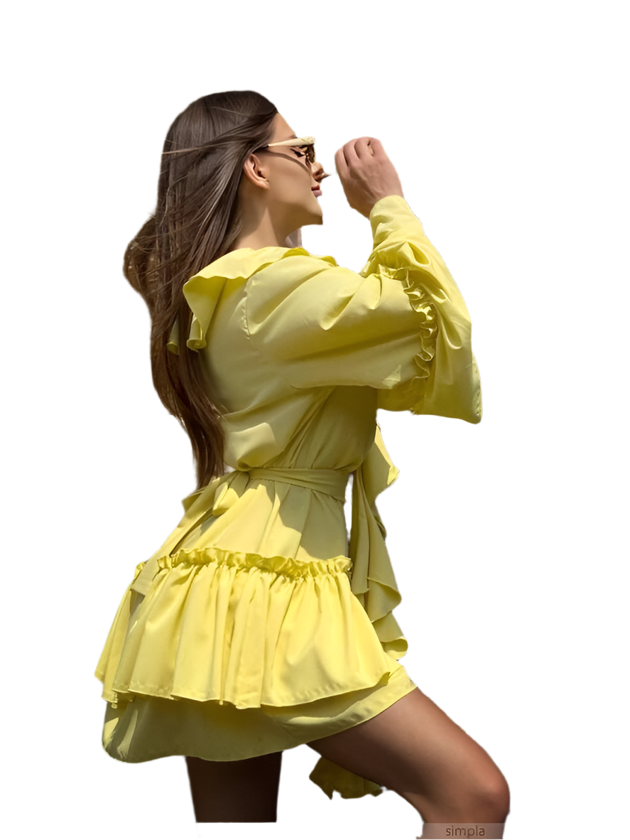 Woman wearing a yellow dress with ruffled details on a white background