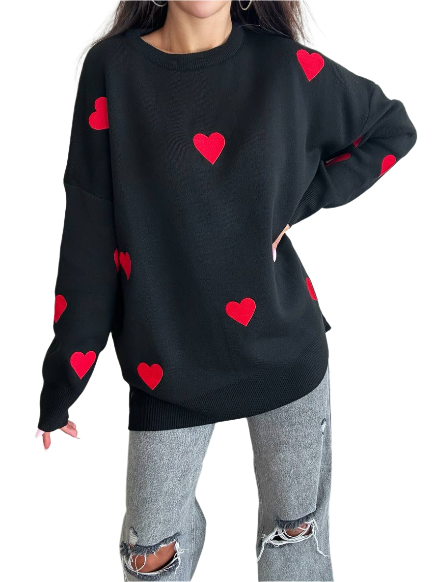 Black sweater with red heart patterns worn by a person on a white background