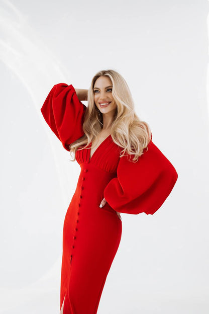 Woman wearing a red dress with puffed sleeves on a white background