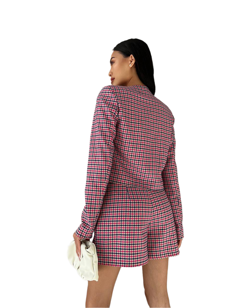 Woman wearing a red and black checkered blazer dress on a white background
