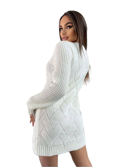 Woman wearing a white knitted dress with a plain background