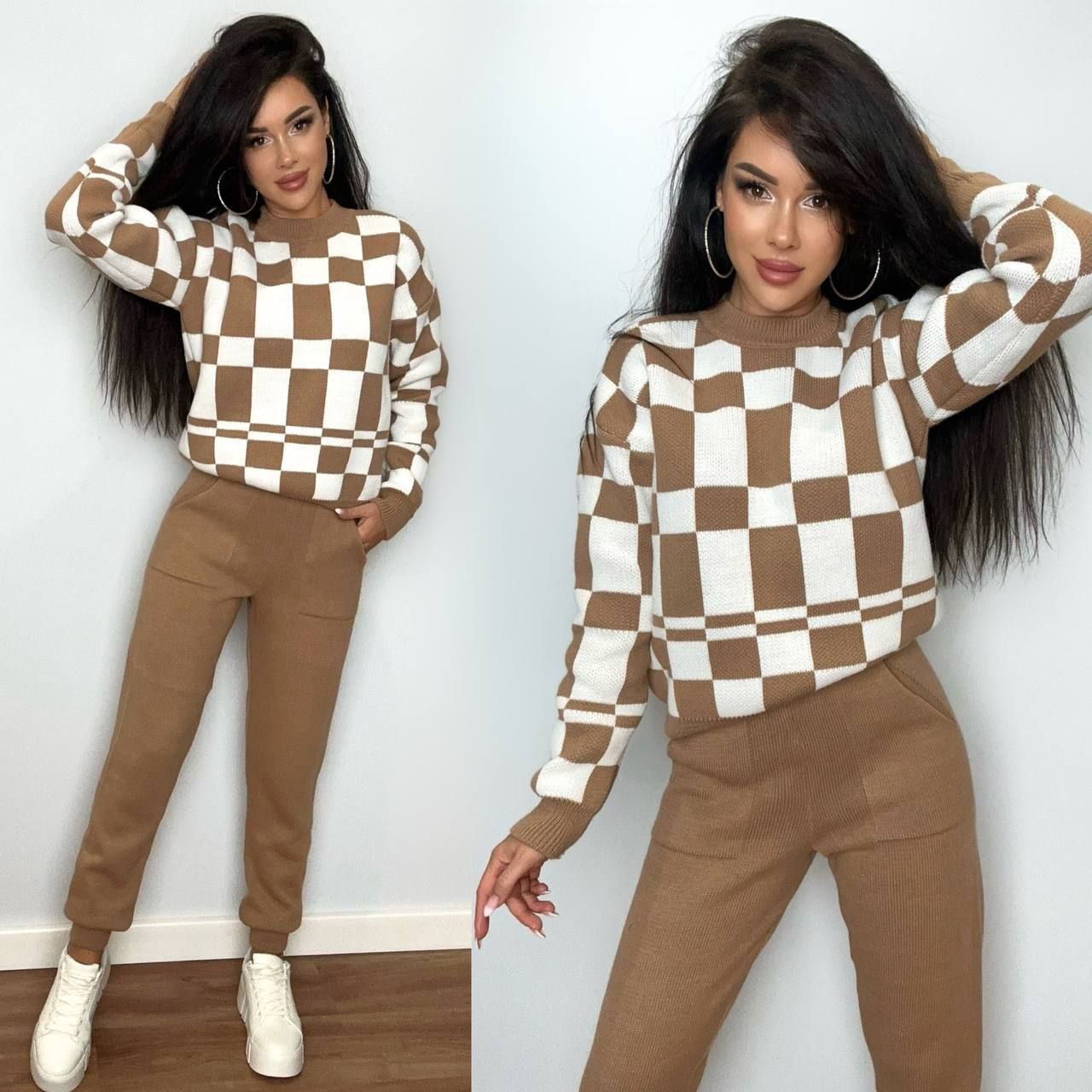 Woman wearing a brown and white checkered sweater with matching pants against a plain wall.