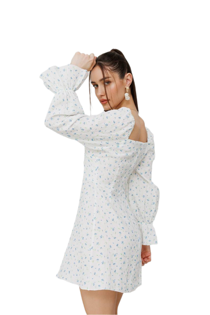 Woman wearing a white floral dress on a white background