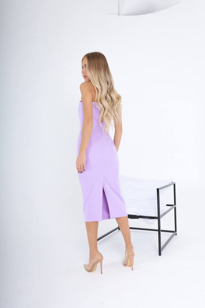 Woman wearing a light purple dress against a white background