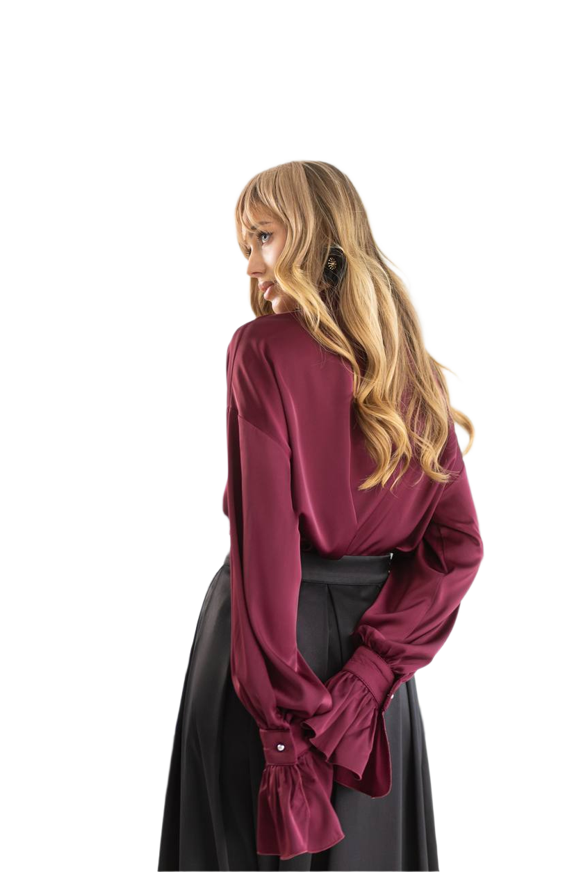 Person wearing a burgundy blouse and black skirt on a white background