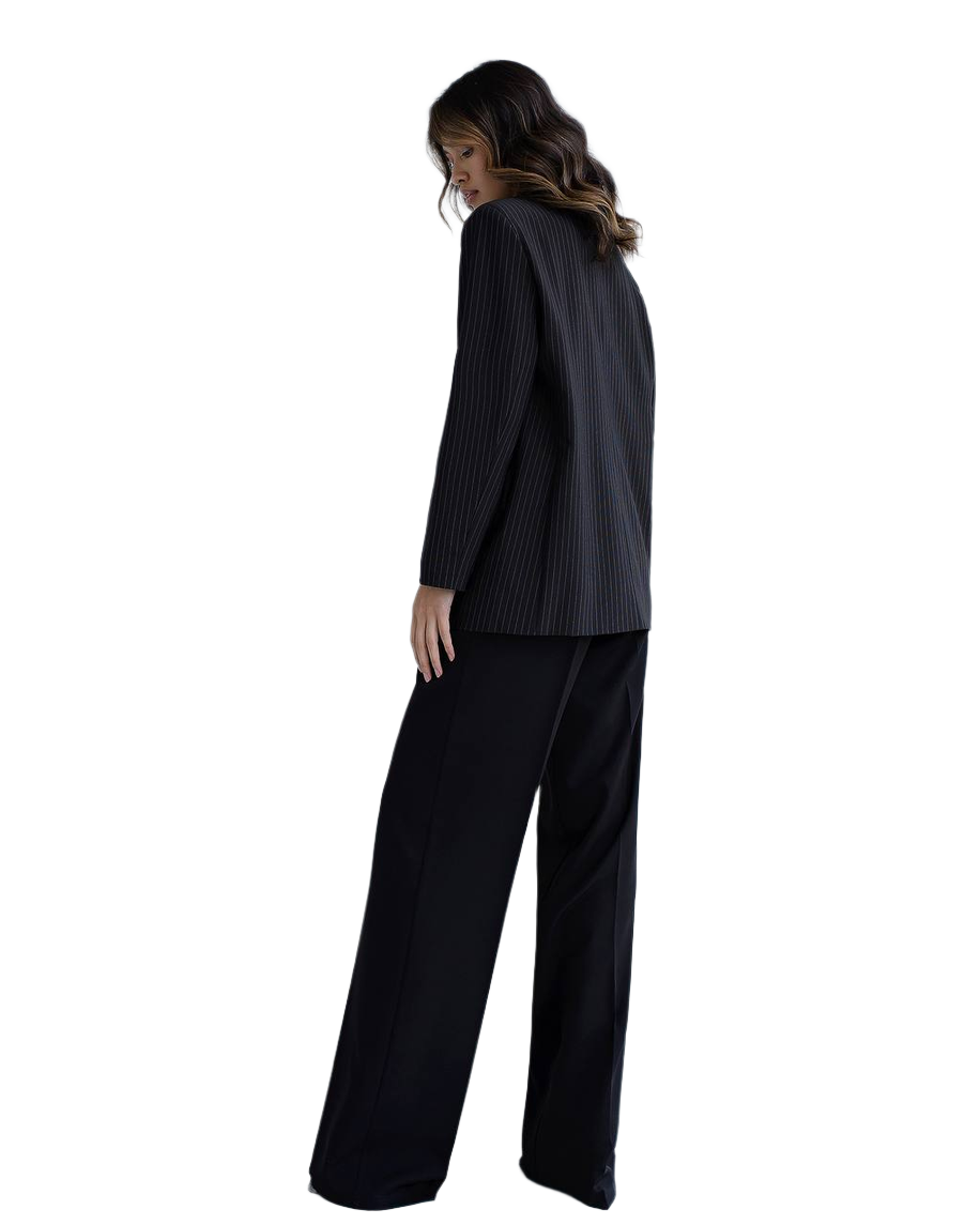 Woman wearing a black suit on a white background