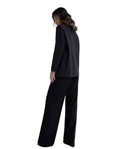Woman wearing a black suit on a white background