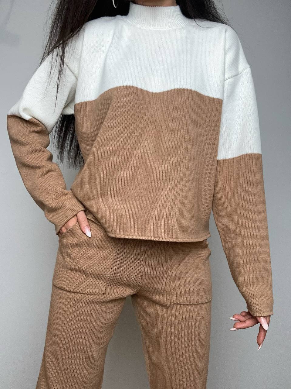 Two-tone sweater with white and brown colors on a gray background