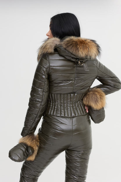 Person wearing a green leather outfit with fur trim on a white background