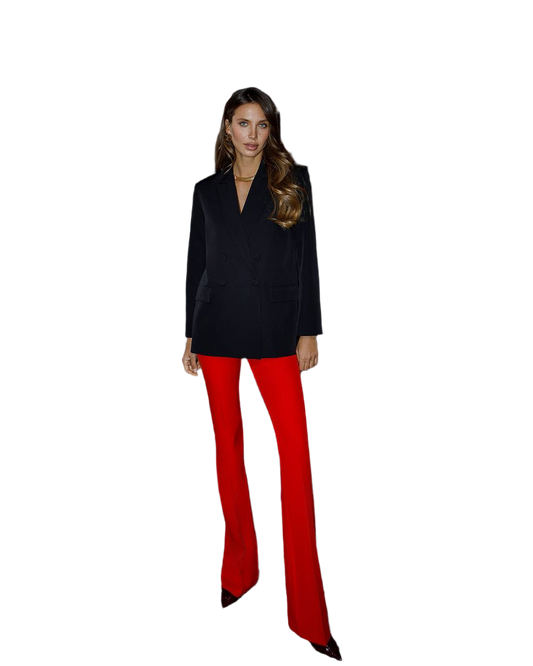 Woman wearing a black top and red pants on a white background