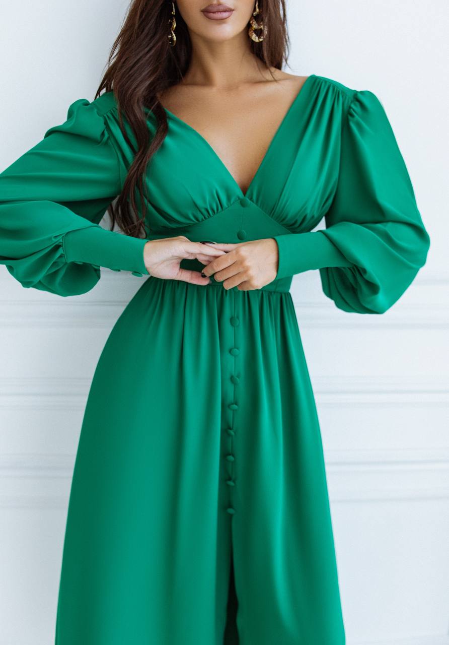 Green dress with long sleeves on a white background
