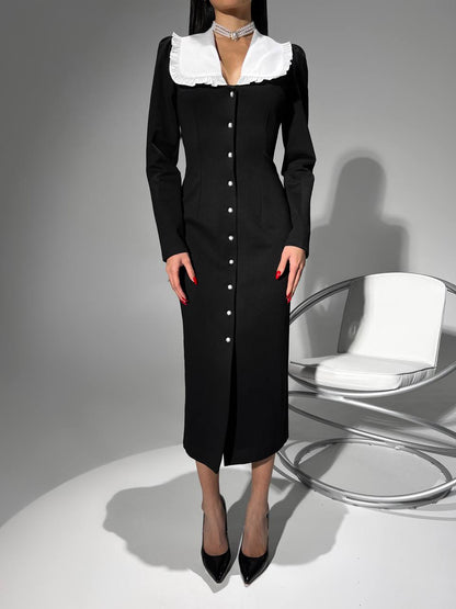Black dress with white collar on a gray background