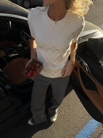 Person holding strawberries next to an open car door
