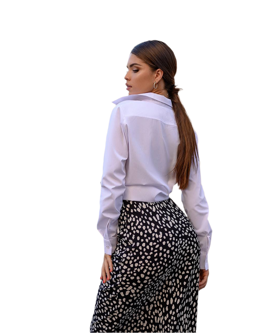 Woman wearing a white shirt and patterned skirt on a white background