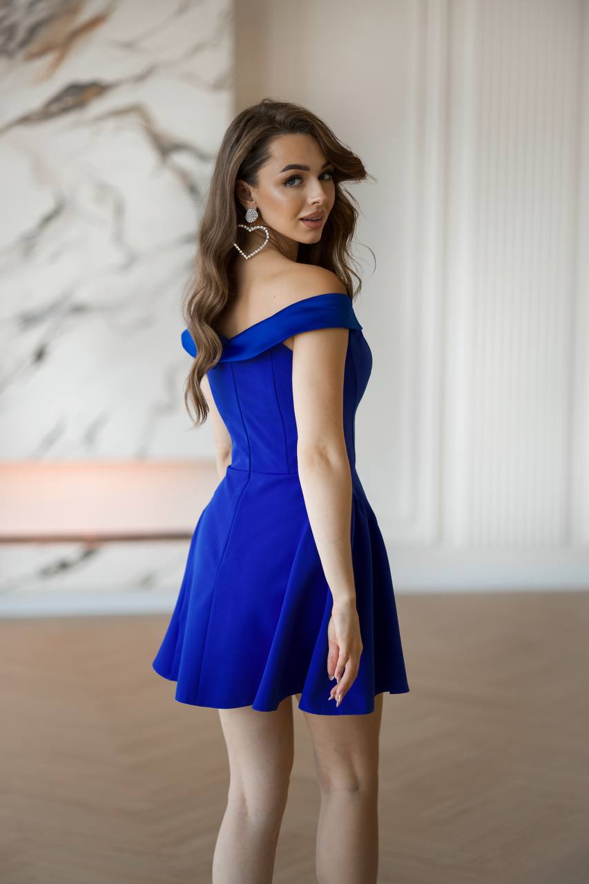 Woman wearing a blue off-shoulder dress indoors