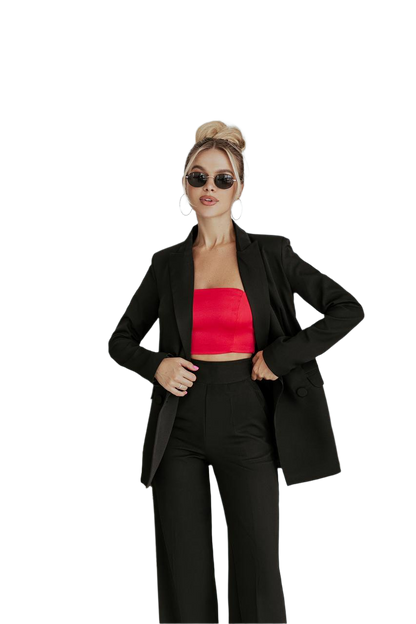 Woman wearing a black suit with a red top on a white background