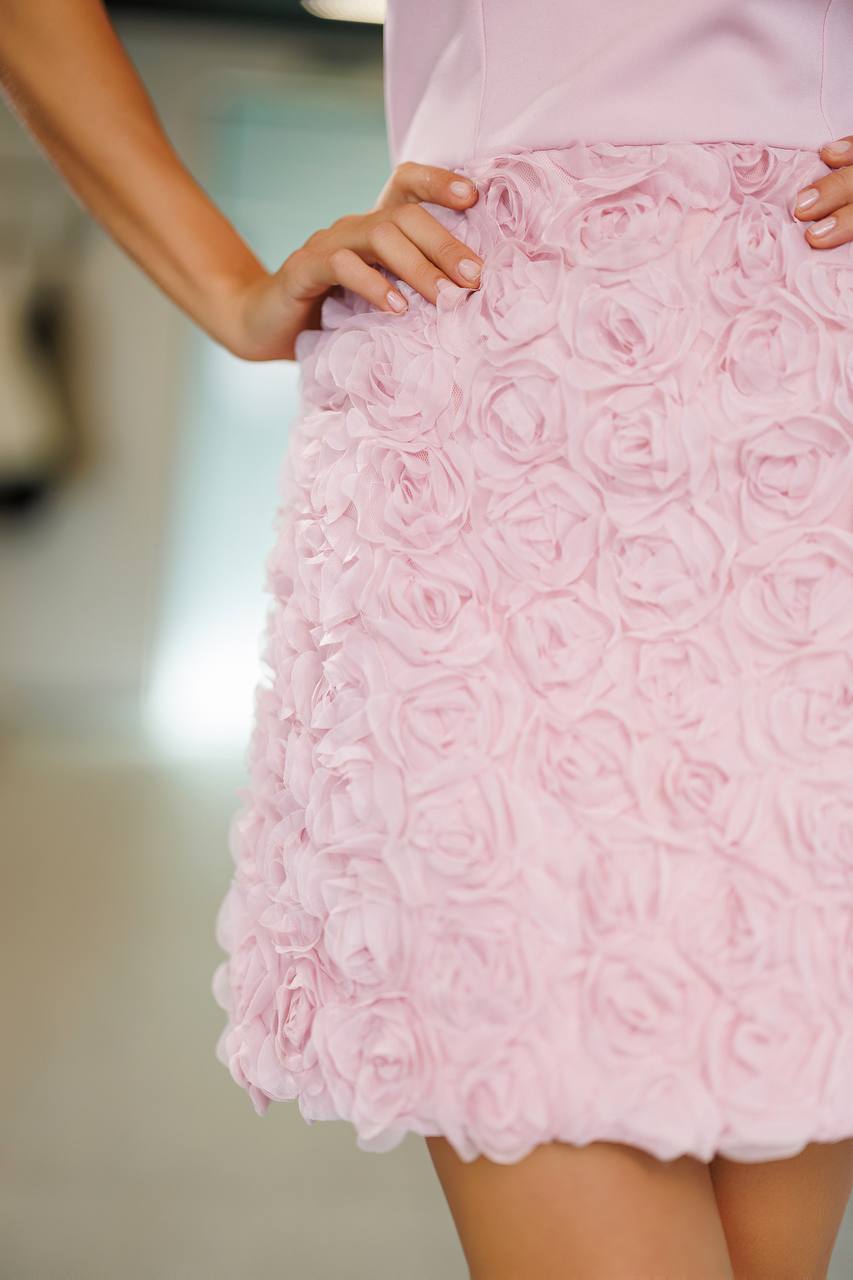 Close-up of a pink lace skirt with a blurred background