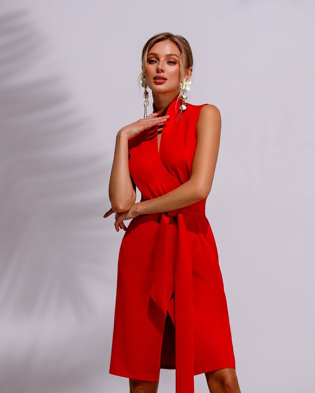 Woman wearing a red dress against a plain background