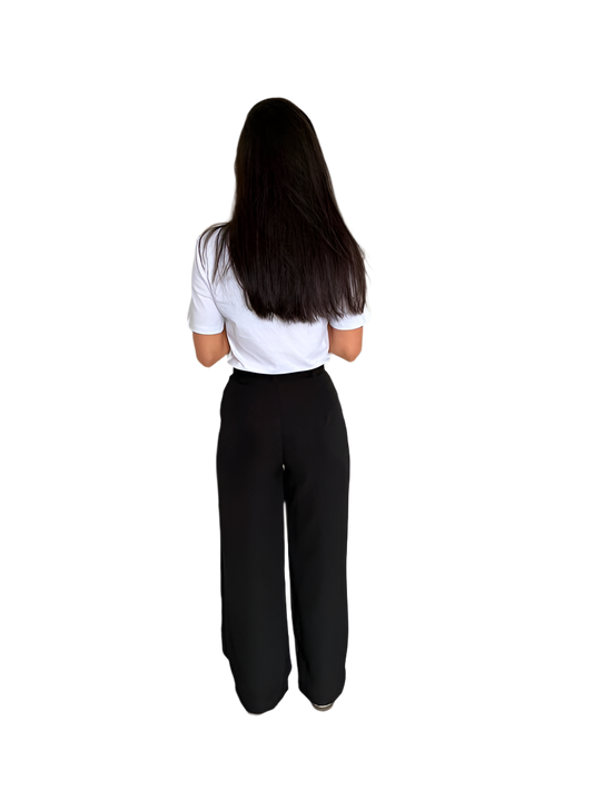 Person wearing a white shirt and black pants on a white background