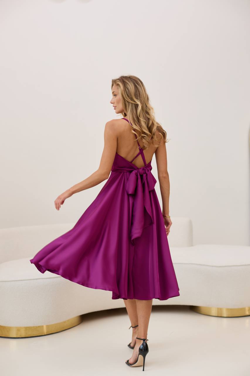 Woman wearing a purple dress in a minimalistic setting