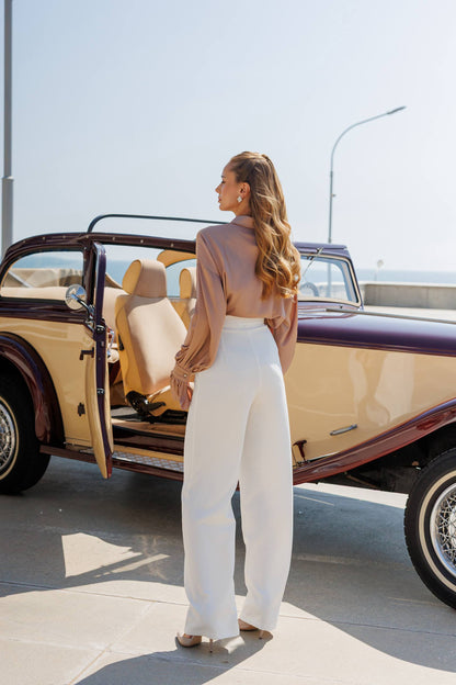 Woman getting out of a vintage car on a sunny day