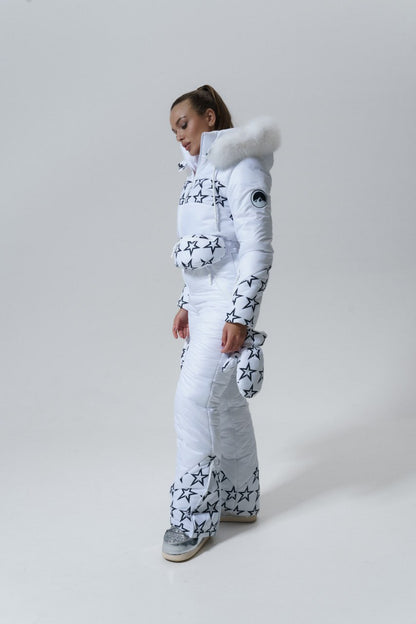 Person wearing a white snowsuit with star patterns on a light gray background