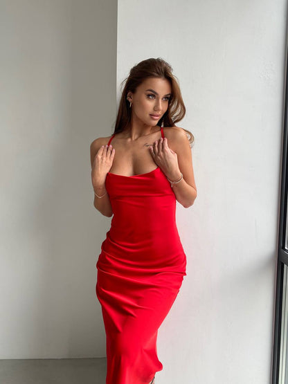 Woman wearing a red dress against a plain background
