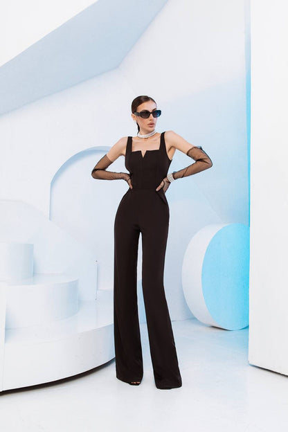 Woman in a black jumpsuit posing against a futuristic white and blue background
