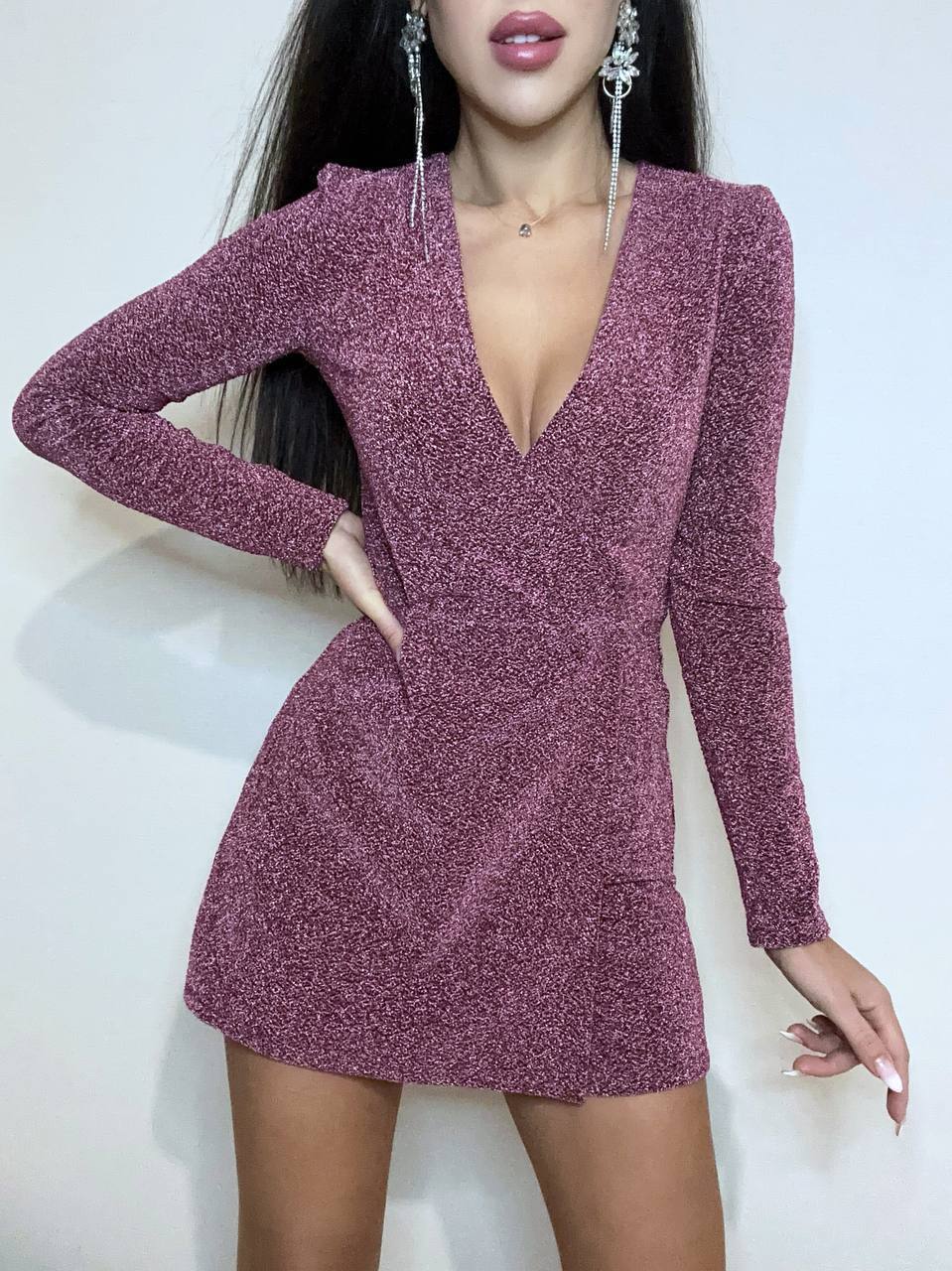 Purple glittery dress worn by a model on a white background