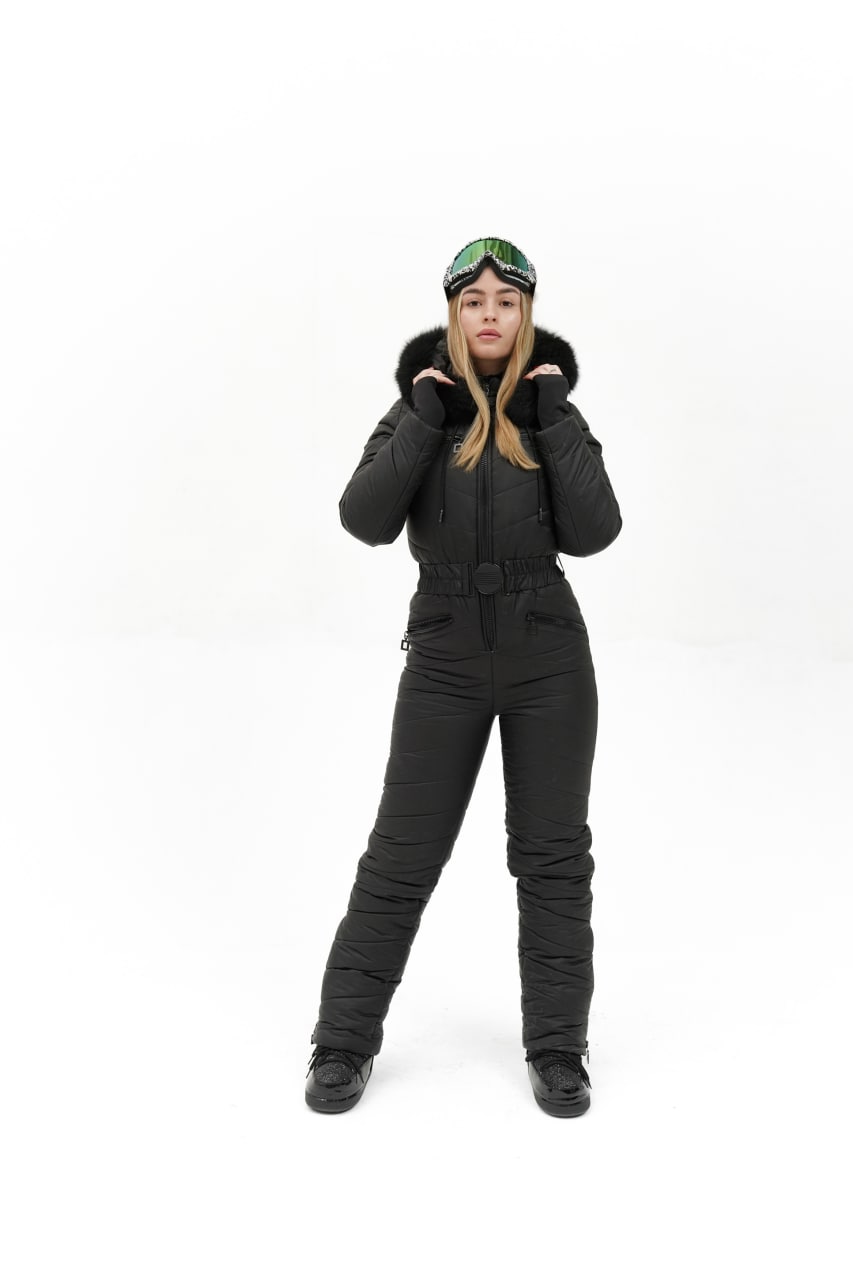 Person wearing a black snowsuit with a hood on a white background