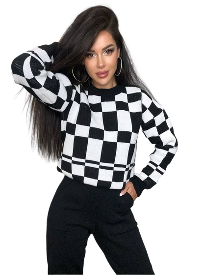Person wearing a black and white checkered sweater on a white background