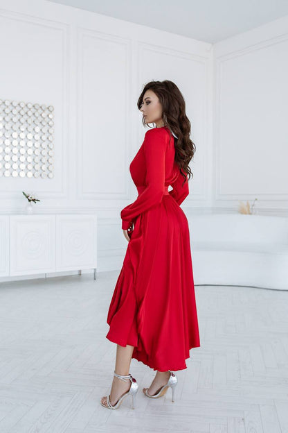Woman in a red dress standing in a minimal white room