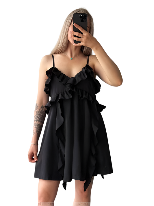 Woman wearing a black ruffled dress against a white background
