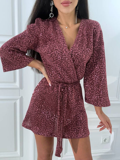 Woman wearing a burgundy textured dress with a white background