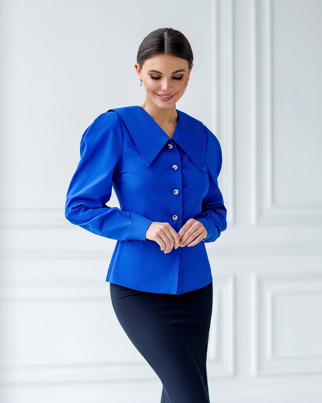 Woman wearing a blue blouse with a white background