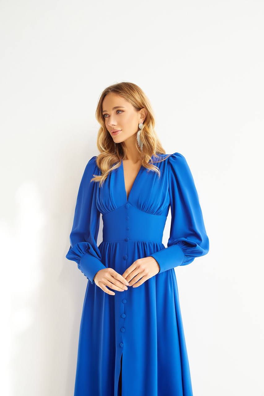 Woman wearing a blue dress against a white background