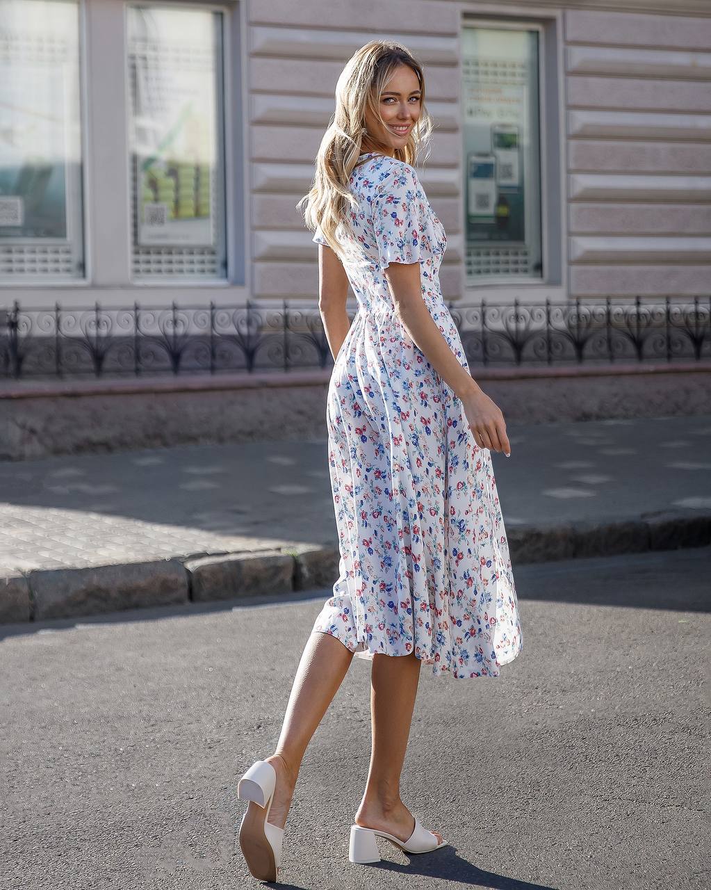 Woman in a floral dress walking on a street