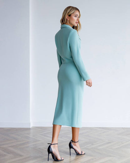 Woman wearing a light blue dress against a white background