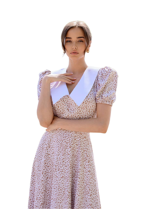 Woman wearing a floral dress with a white collar on a white background