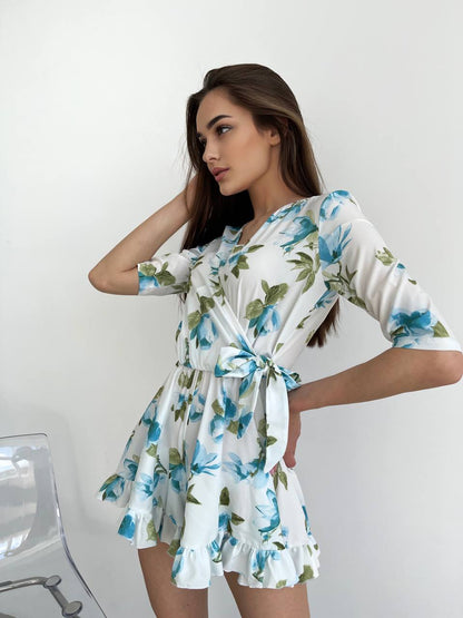 Woman wearing a floral dress against a white background