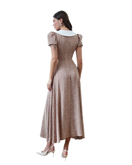 Woman wearing a patterned dress on a white background