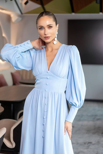 Woman wearing a light blue dress in an indoor setting