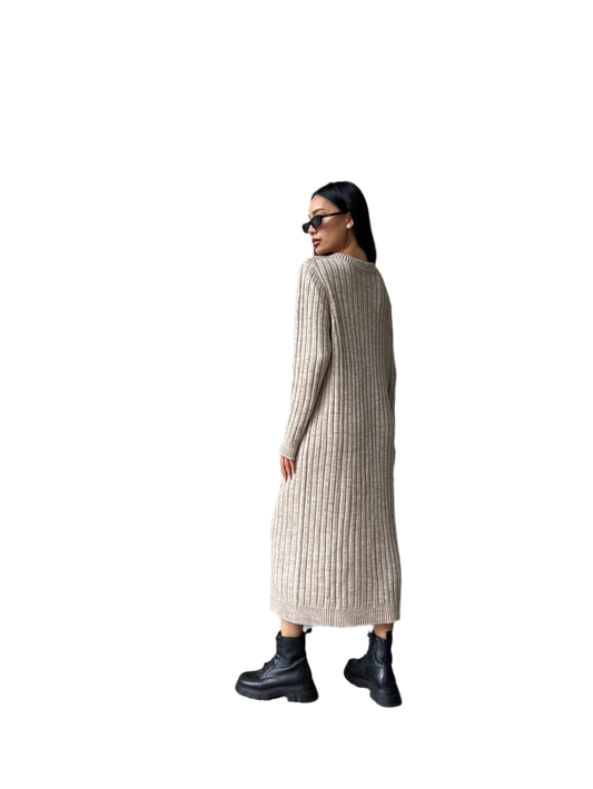 Woman wearing a long ribbed knit dress on a white background