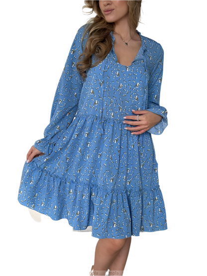 Woman wearing a blue floral dress on a white background