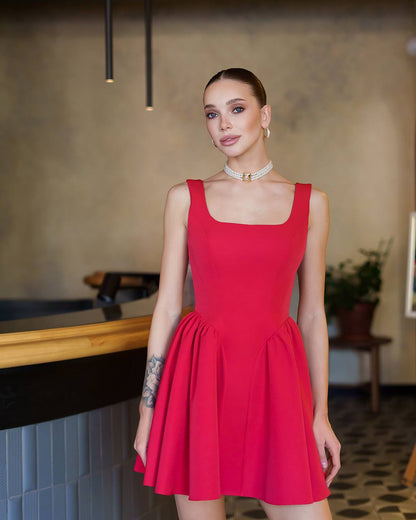 Woman wearing a red dress in an indoor setting