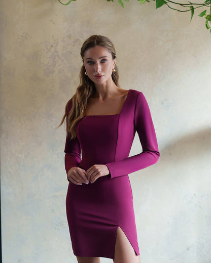 Woman wearing a burgundy dress with a plain background