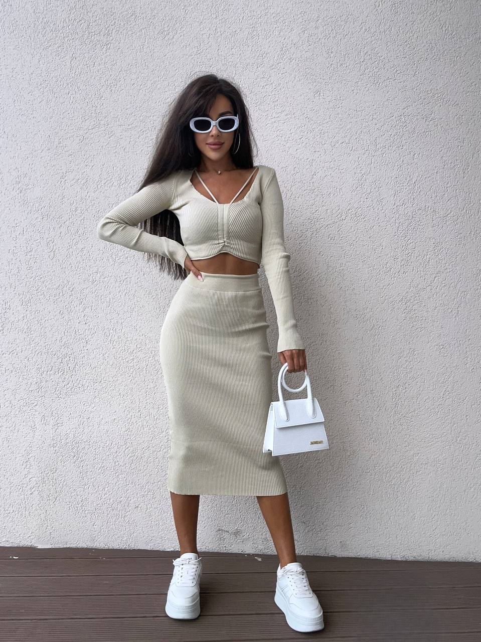 Woman in a stylish outfit with a white background